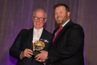 Dan McCaffery accepts Legendary Landmark Award from Clayton McCaffery