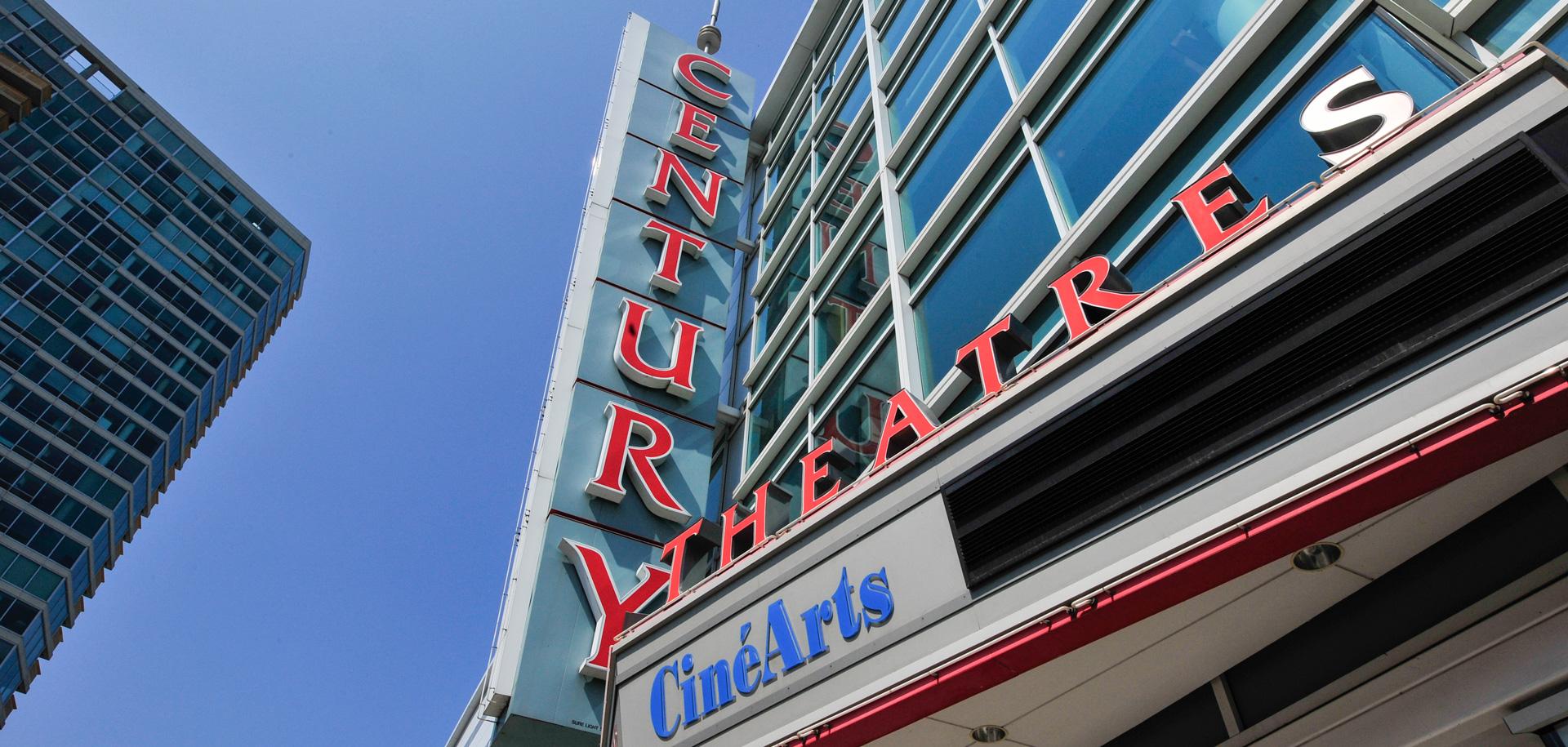 Looking up at the signage for CineArts at Church Street Plaza.